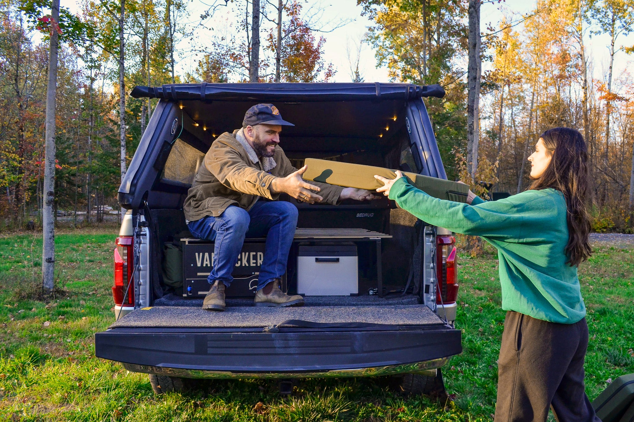 Installation process of the double bed inside the pickup truck camper box.
