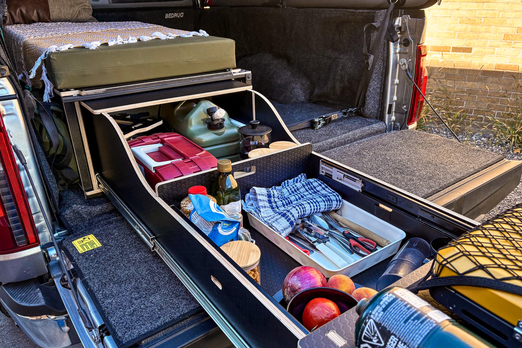 Storage compartments inside the pickup truck camper box.