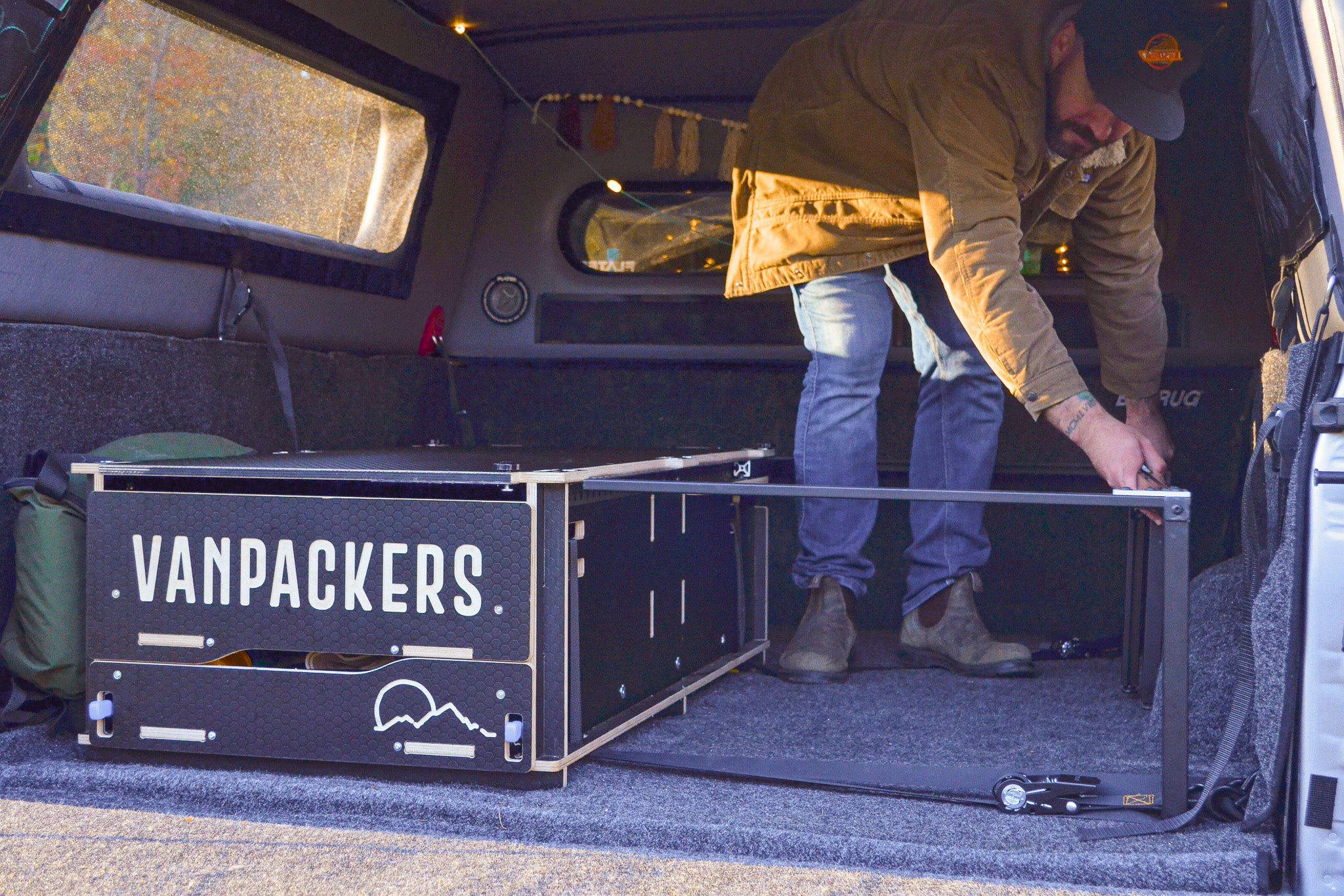 Installation of the bed rails for the double bed inside the pickup truck camper box.