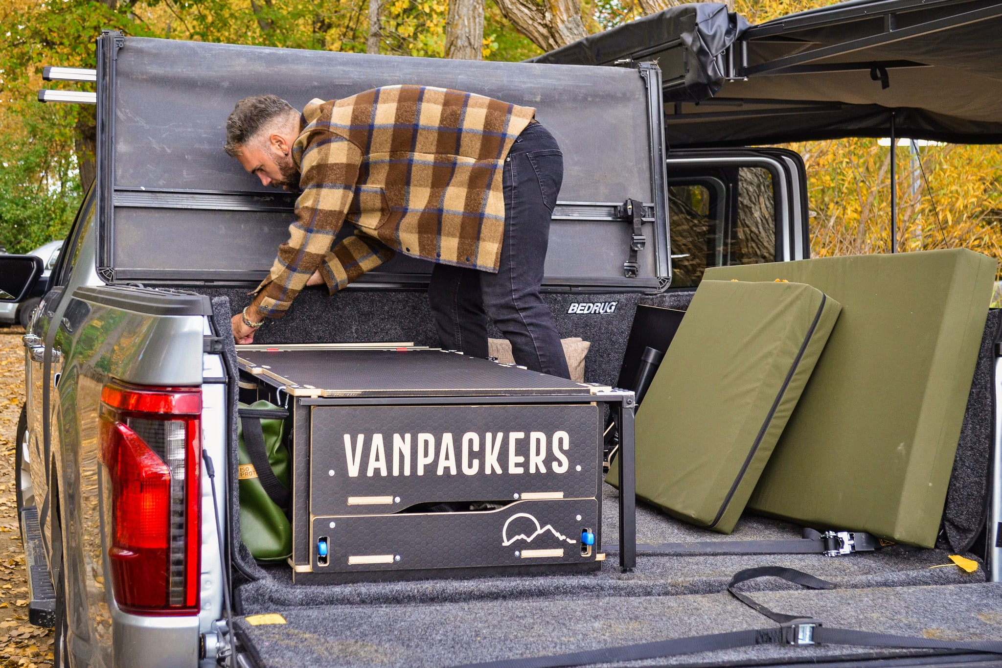 Installation of the single bed inside the pickup truck camper box.